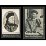 Two albums containing approximately 216 Ogdens Guinea Gold photographic cigarette cards from various