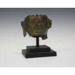 A Chinese bronze Buddha head fragment, probably 17th century, mounted on an ebonized stand, total