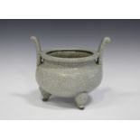 A Chinese crackle glazed celadon tripod censer, the circular squat body with moulded panels