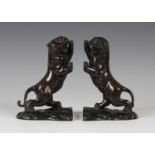 A pair of Japanese brown patinated bronze tiger bookends by Housen, early 20th century, each