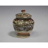 A Japanese Satsuma earthenware pot and cover, Meiji period, the compressed globular body painted and