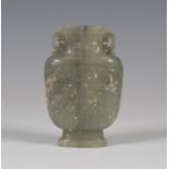 A Chinese celadon green jade vase, Qing dynasty, the well-hollowed flattened spade-shaped body