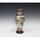 A Chinese famille rose crackle glazed porcelain vase and cover, early 20th century, the baluster