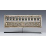 An Indian bone rectangular panel, 18th/19th century, the frame carved in relief with a border of