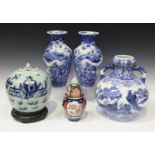 A pair of Japanese Arita blue and white porcelain vases, Meiji period, each baluster body painted