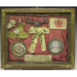 A group of royal related curios, including a dress adornment and a piece of paper inscribed '