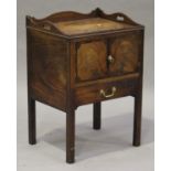 A George III mahogany night table, the galleried top with pierced handles above a cupboard and