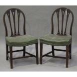 A pair of early 20th century George III style mahogany arched back dining chairs with carved