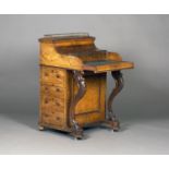 A mid-Victorian walnut piano-top Davenport, the pop-up top above a hinged serpentine lid revealing a