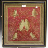 A Victorian woolwork panel depicting six owls perched on branches, worked in coloured wools and