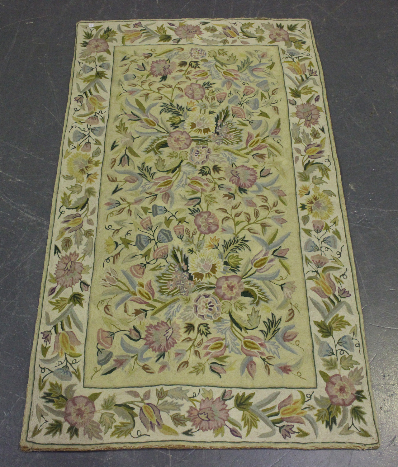 A 20th century chain stitch rug, the cream field worked with overall flowers, 153cm x 88cm, together