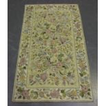 A 20th century chain stitch rug, the cream field worked with overall flowers, 153cm x 88cm, together