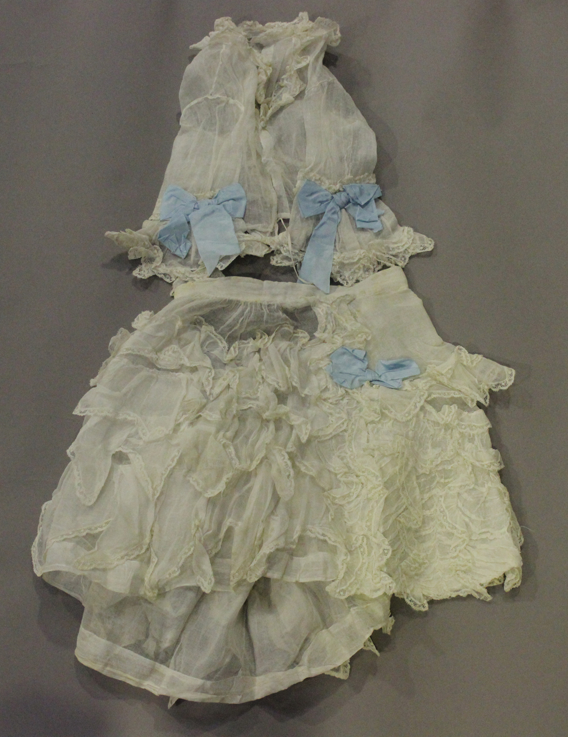 A selection of mainly 19th century infants' clothing, including a gauze and applied lace skirt