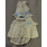 A selection of mainly 19th century infants' clothing, including a gauze and applied lace skirt