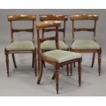 A set of four William IV rosewood bar back dining chairs with carved foliate centre rails, the