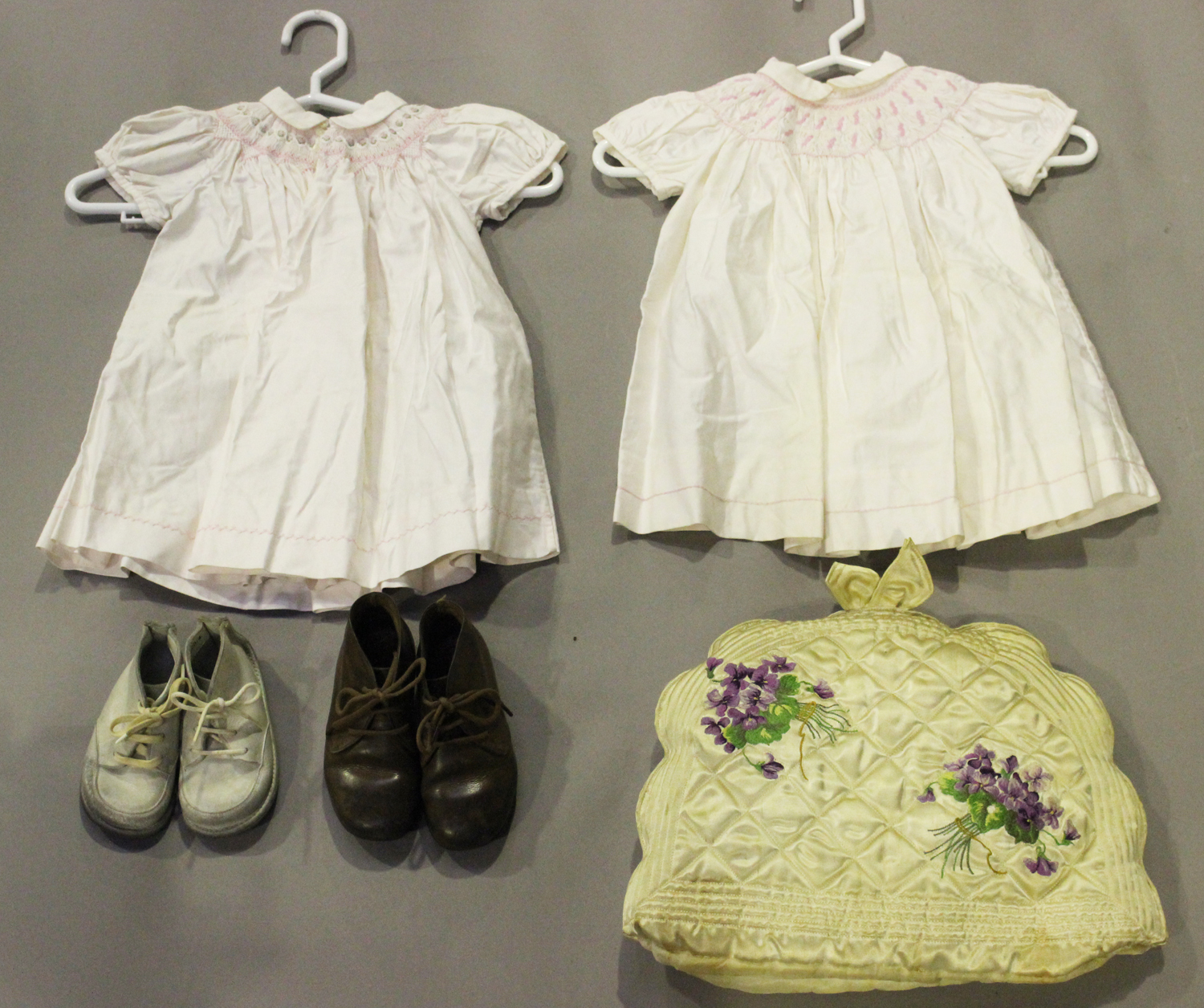 A small group of early/mid-20th century infants' clothing, including two pairs of leather boots, two