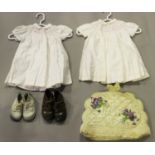 A small group of early/mid-20th century infants' clothing, including two pairs of leather boots, two