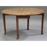 An early 20th century George III style figured mahogany oval drop-flap breakfast table, the top