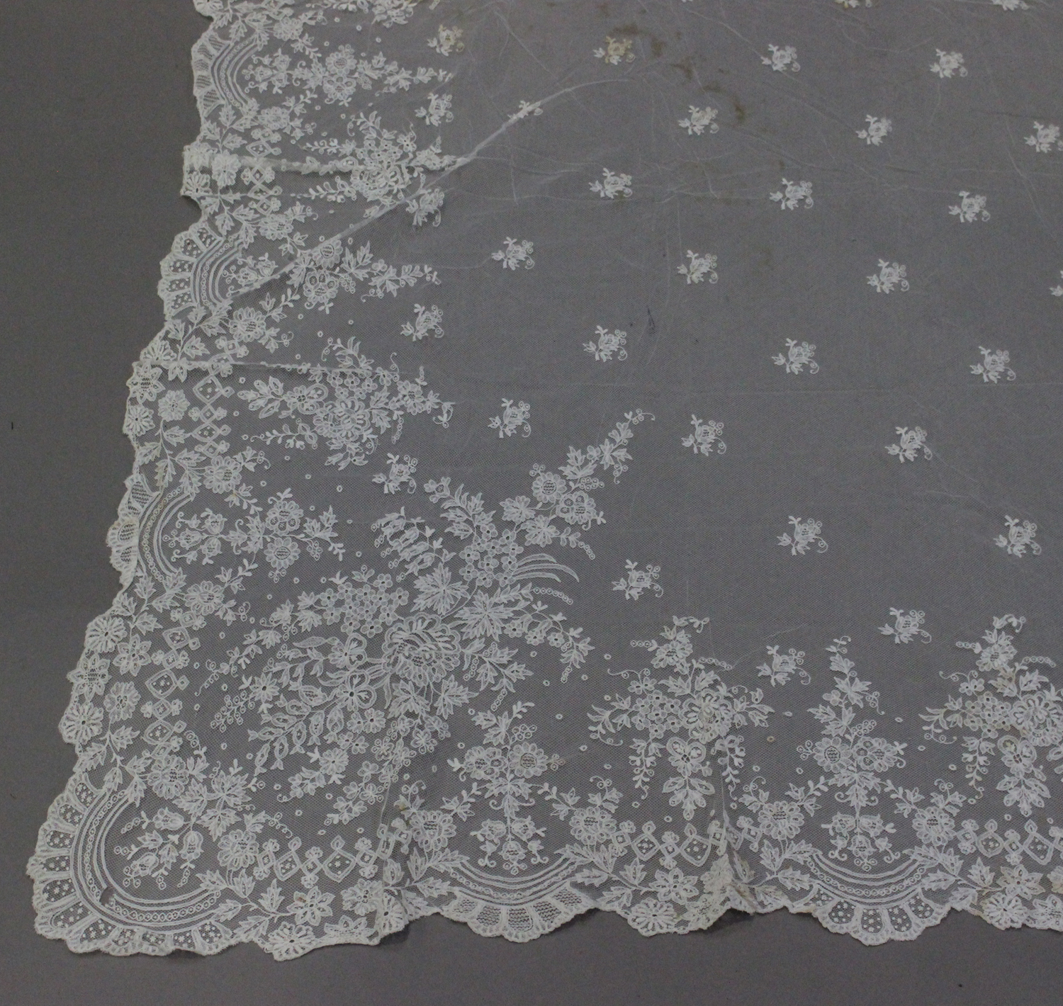 A late 19th/early 20th century Continental white net and lacework wedding veil with a foliate border - Image 3 of 3