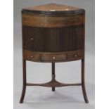 A late George III mahogany corner washstand, the hinged top above a tambour fronted cupboard and a