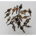 A collection of twenty mostly advertising pocket and fob watch keys, mostly circa 1900, in a variety