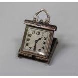 An Art Deco shaped square cased lady's sprung action folding travelling watch, the circular jewelled