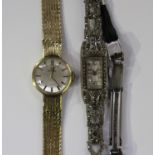 An Omega 9ct gold lady's bracelet wristwatch, the signed silvered dial with black baton hour