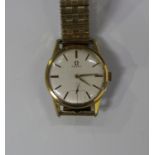 An Omega gilt metal fronted and steel backed gentleman's wristwatch, the signed silvered dial with