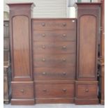 A Victorian mahogany castle top three-section wardrobe, fitted with five drawers flanked by arched