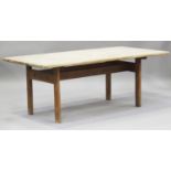 A mid-20th century pine kitchen table, possibly Scandinavian, the rectangular top on curved block