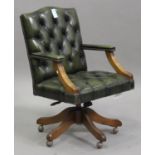 A 20th century reproduction green buttoned leather revolving office chair with brass studwork