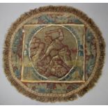 A late 17th century circular tapestry panel depicting a man holding a club aloft, within a foliate