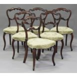 A set of six mid-Victorian rosewood spoon back dining chairs with carved decoration, the upholstered