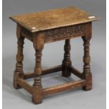 A 20th century Jacobean Revival oak joint stool, on turned and block legs united by stretchers,