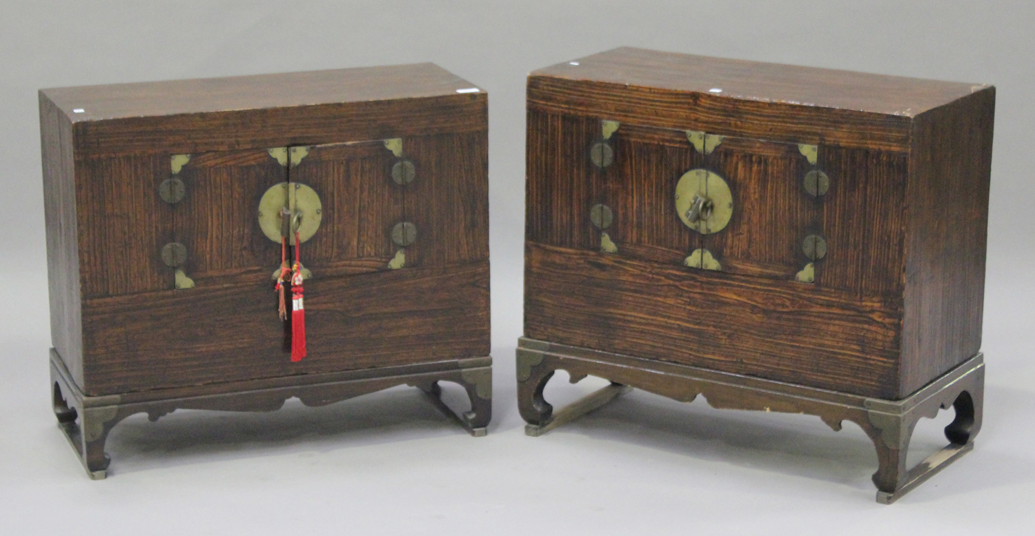 A near pair of 20th century South-east Asian stained softwood low side cabinets, each fitted with