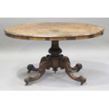 A mid-Victorian burr walnut oval tip-top breakfast table, raised on a carved stem and four