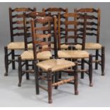 A set of six 19th century stained ash ladder back dining chairs with rush seats, on turned legs