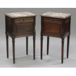 A pair of 20th century French mahogany bedside cupboards, each inset with a marble top above a