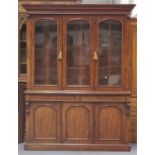 A mid-Victorian figured mahogany bookcase cabinet with overall line inlaid ebony borders, the