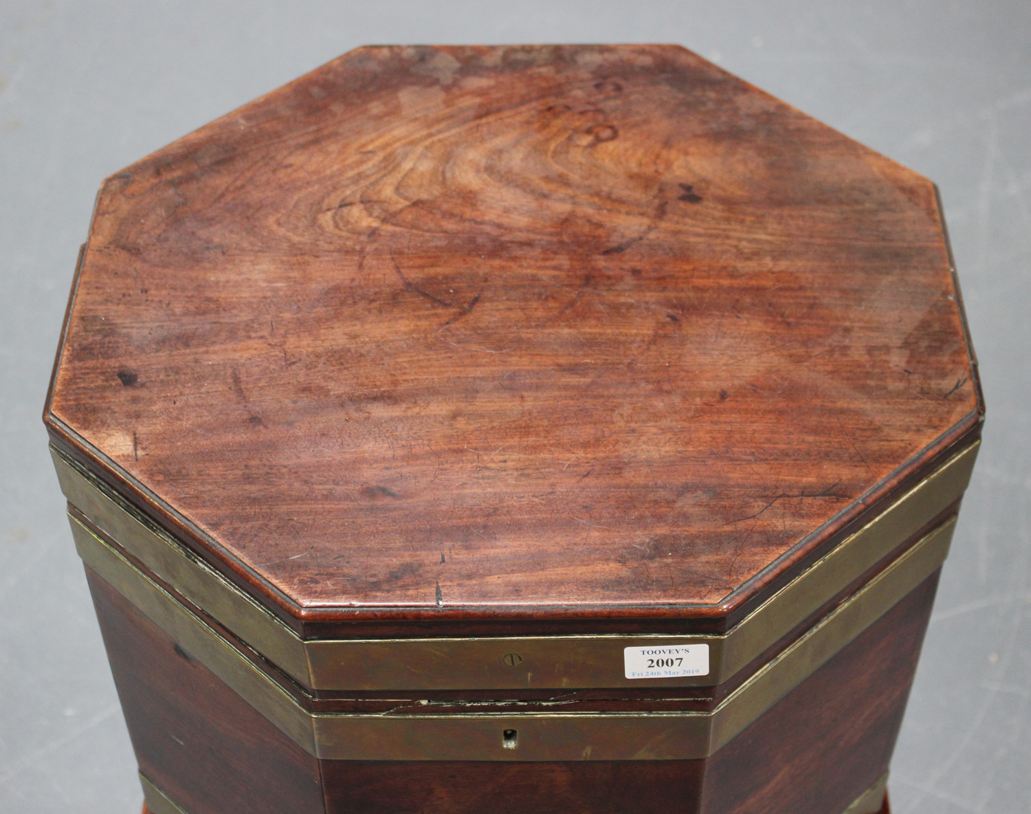 A George III mahogany and brass bound cellaret of octagonal form, the hinged lid enclosing a lead- - Image 4 of 5