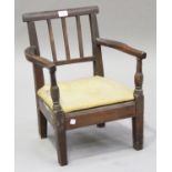 A George III provincial ash child's armchair with a comb back and block legs, height 51cm, width