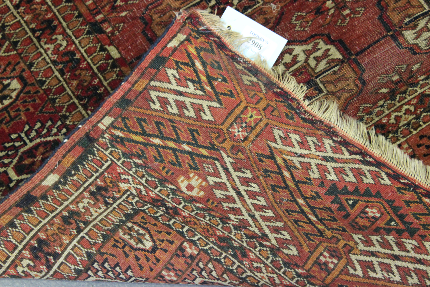 A Tekke rug, West Turkestan, early 20th century, the pale claret field with three columns of seven - Image 2 of 2