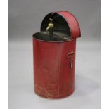 A '30 Gallons' red painted tin oil cabinet, the hinged lid enclosing a brass dispensing tap,