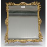 A late Victorian carved giltwood wall mirror with a shaped foliate frame, 45cm x 40cm.Buyer’s