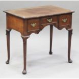 A George II style mahogany lowboy, probably 18th century, fitted with three drawers, raised on