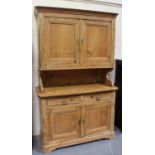 A Victorian stripped pine kitchen dresser, the cabinet back above two frieze drawers and a pair of