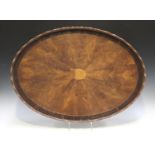 A 19th century figured mahogany galleried oval tea tray with a radially veneered centre and