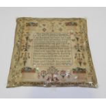 A George III needlework sampler, dated 1803, the central verse surrounded by colourful plants, fruit