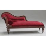 A Victorian mahogany framed chaise-longue with carved decoration, upholstered in red velour,