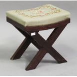 A 20th century mahogany 'X' framed stool with a floral tapestry seat, height 66cm, width 46cm.